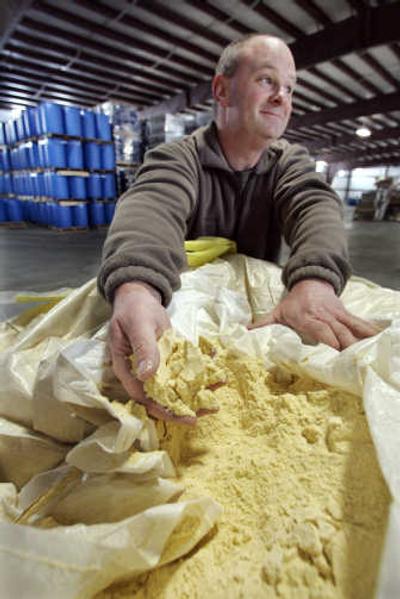
Bill Scott, master distiller for Distilled Resources, shows off a huge container of organic corn meal at the company's warehouse in Rigby, Idaho. Associated Press photos
 (Associated Press photos / The Spokesman-Review)