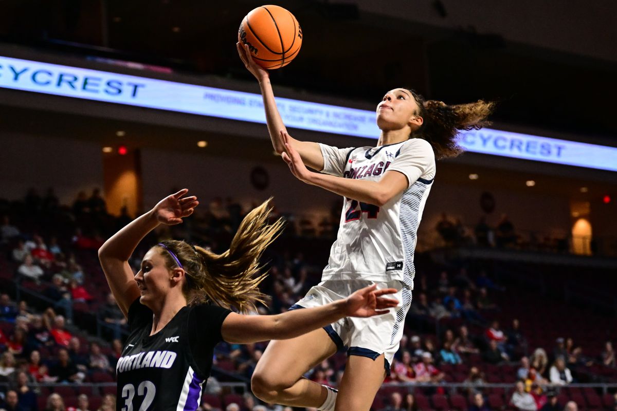 Gonzaga Bulldogs guard McKayla Williams (24) reaches for a layup against Portland Pilots guard Kelsey Lenzie (32) during the second half of a WCC tournament championship basketball game on Tuesday, March 7, 2023, at the Orleans Arena in Las Vegas, Nev. The Portland Pilots won the game 63-60.  (Tyler Tjomsland/The Spokesman-Review)