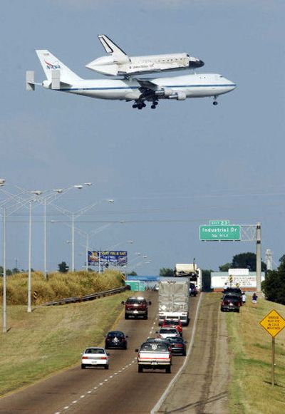 
The space shuttle Discovery, riding piggyback on a specially modified 747, makes its descent to Barksdale Air Force Base on Friday in Bossier City, La., for a refueling stop. Discovery left Edwards Air Force in California Friday morning. 
 (Associated Press / The Spokesman-Review)