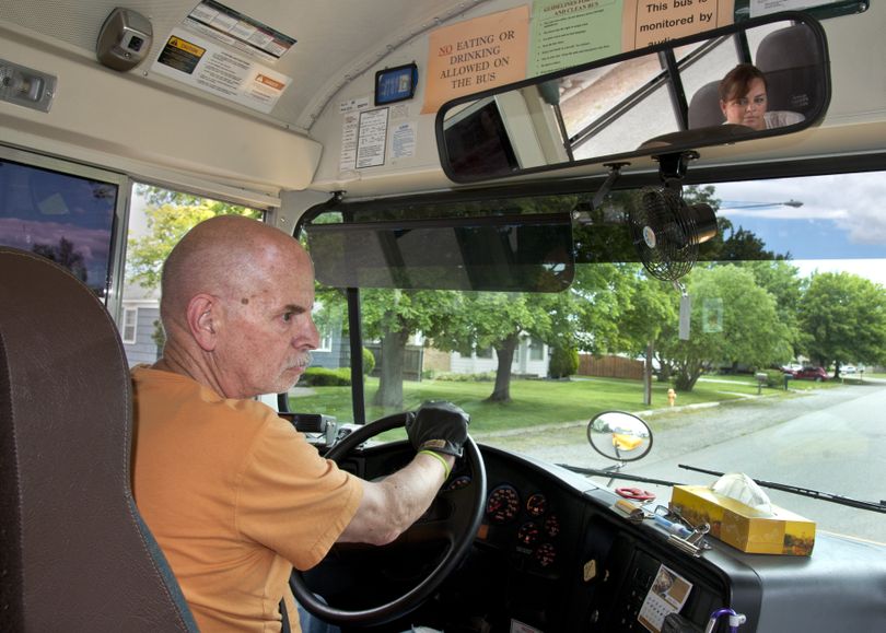 Greg Williams and Colleen Ramsey (reflected in mirror) drive the streets of Spokane Valley during a training session last week for the West Valley School District. (Dan Pelle)