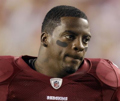 Former Washington Redskins running back Clinton Portis is one of 10 former NFL players who have been charged with defrauding the league’s healthcare benefit program. (Rob Carr / Associated Press)