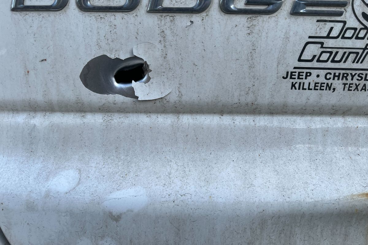 A neighborhood resident’s vehicle was damaged by a bullet from a drive-by shooting near Liberty Park Wednesday that killed a 17-year-old and wounded two others.  (Quinn Welsch/THE SPOKESMAN-REVIEW)