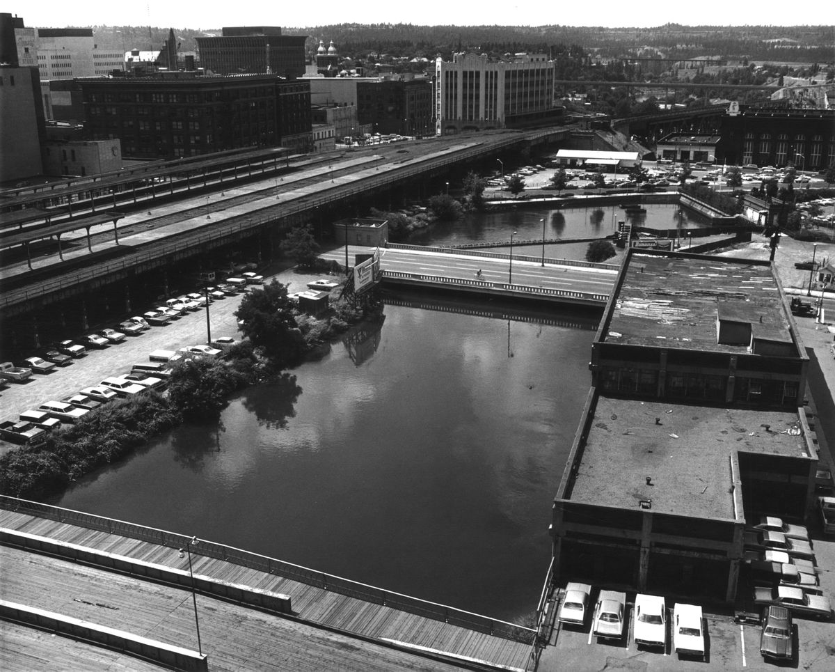 1972 - This photo, taken just before Expo ’74 demolition began in earnest, contains symbols of Spokane’s past, including the Milwaukee and Union Pacifc elevated tracks at left, the Montgomery Ward store and the Railway Mail Service terminal at lower right, all arranged around the south channel of the Spokane River.  (THE SPOKESMAN-REVIEW PHOTO ARCHIVE)