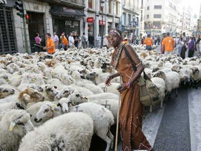 
An African woman helps guide a flock of sheep through the streets of Madrid on Sunday. Associated Press
 (Associated Press / The Spokesman-Review)