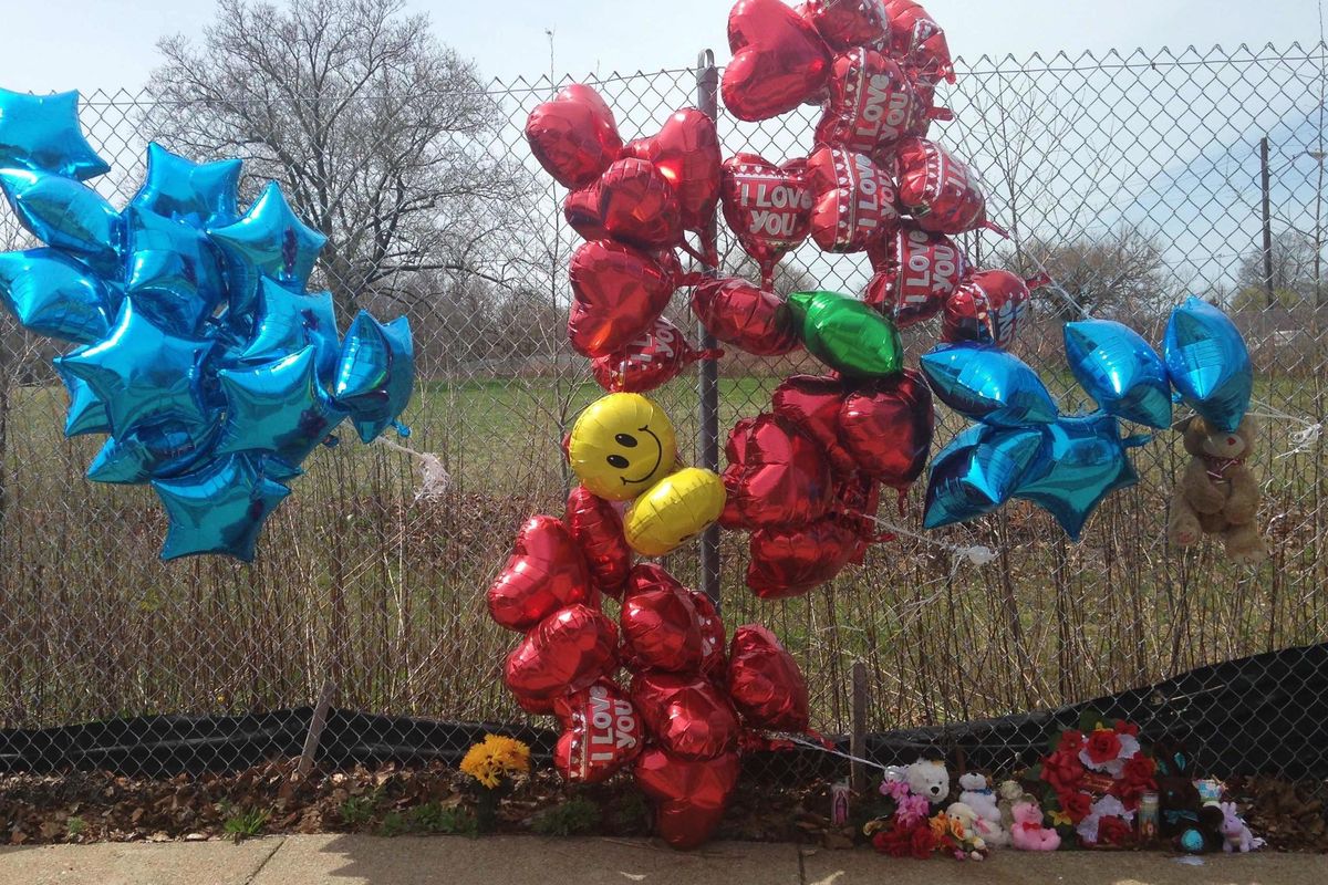 A makeshift memorial sits along a fence Monday, near where Robert Godwin Sr., was killed in Cleveland. Police said Steve Stephens killed Godwin on Sunday and posted the video on Facebook. (Mike Householder / Associated Press)