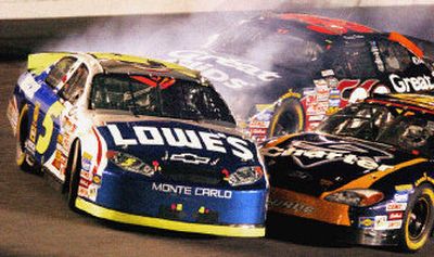 
The car of Kyle Busch (5) gets turned sideways by Kasey Kahne, background, and Carl Edwards, lower right, coming through the tri-oval during the  Winn-Dixie 250. 
 (Associated Press / The Spokesman-Review)