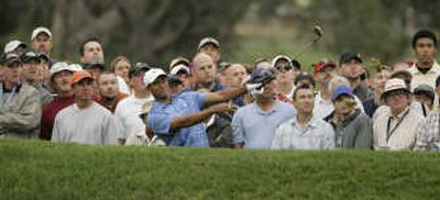 
Tiger Woods – and a few of his friends – look at his shot from the rough on the first hole during the first round of the U.S. Open championship at Torrey Pines.Associated Press
 (Associated Press / The Spokesman-Review)