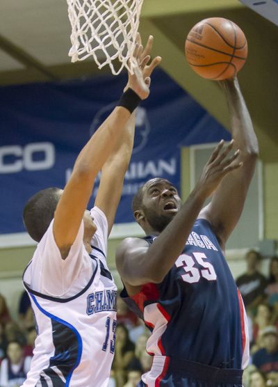Gonzaga center Sam Dower Jr., right, attempts to control a rebound as his teammate center Przemek Karnowski looks on in the first half of an NCAA college basketball game at the Maui Invitational on Tuesday in Lahaina, Hawaii.  (Associated Press)
