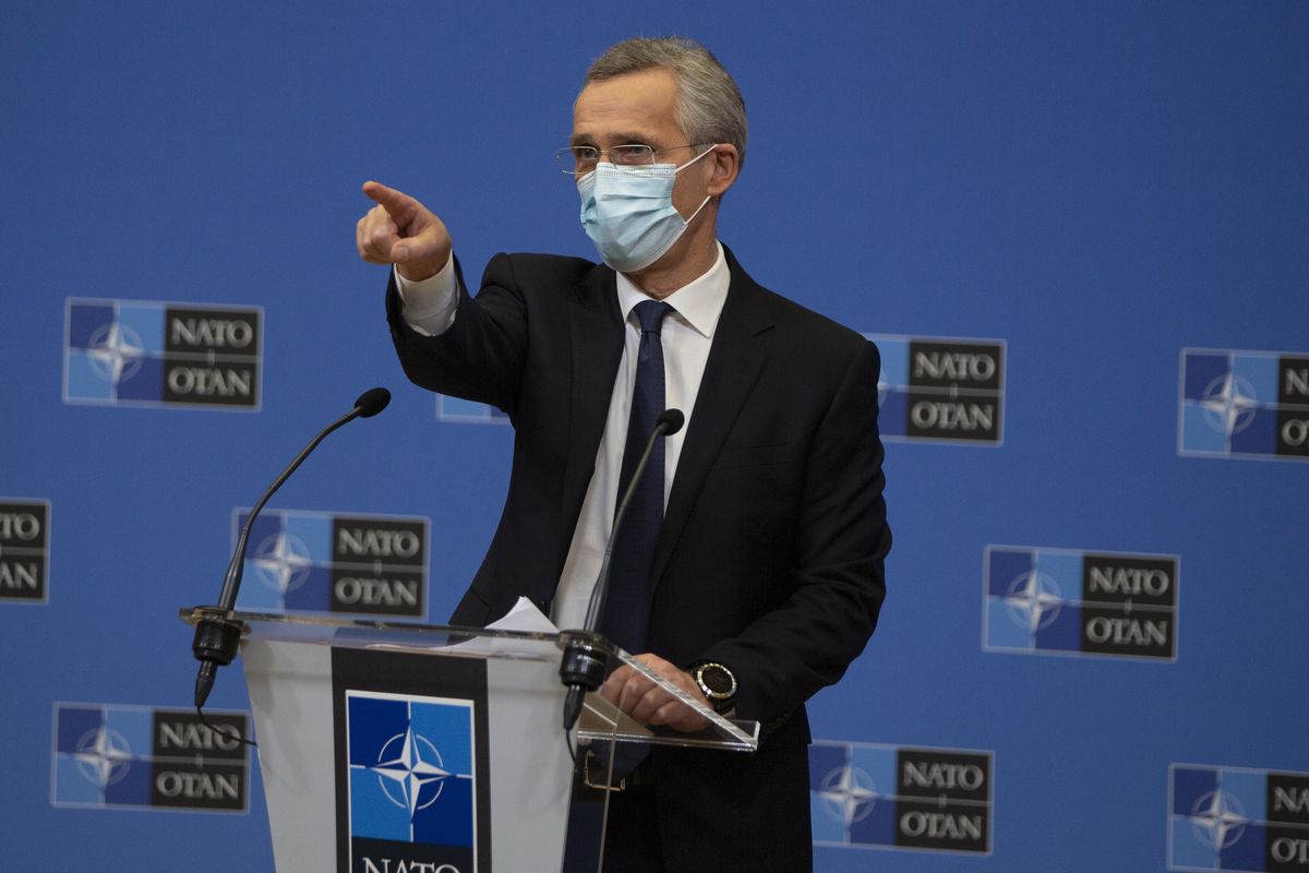 NATO Secretary General Jens Stoltenberg wears a protective face mask as he prepares to speak during a media conference, after a meeting of NATO defense ministers in video format, at NATO headquarters in Brussels on Thursday, Feb. 18, 2021. (Virginia Mayo)
