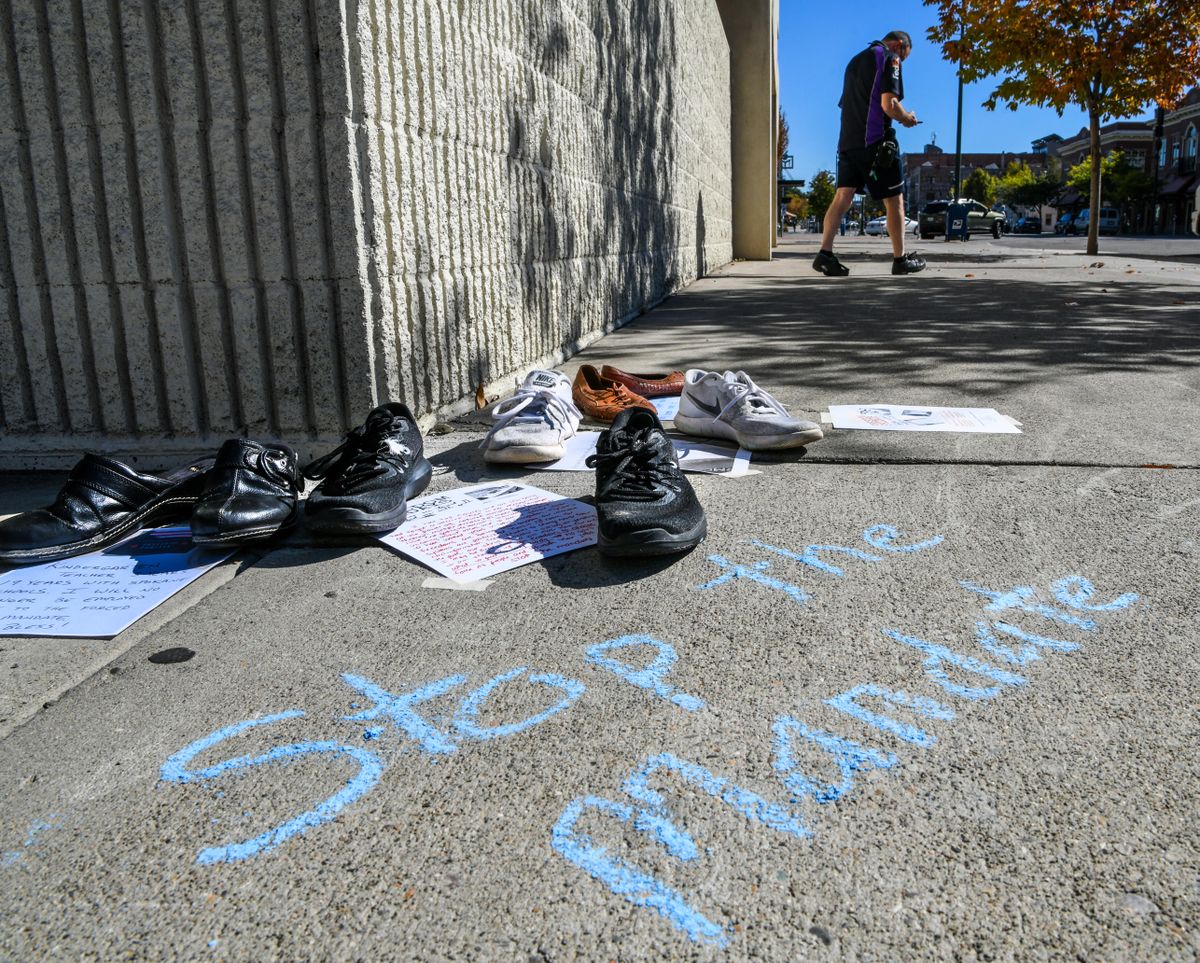 Shoes line the sidewalk along Bernard Street and Main Avenue outside the Spokane Public Schools Building, Friday, Sept. 24, 2021, in downtown Spokane. The Freedom Fridays, Together we stand or united we fall protest shows support for medical freedom.  (DAN PELLE/THE SPOKESMAN-REVIEW)