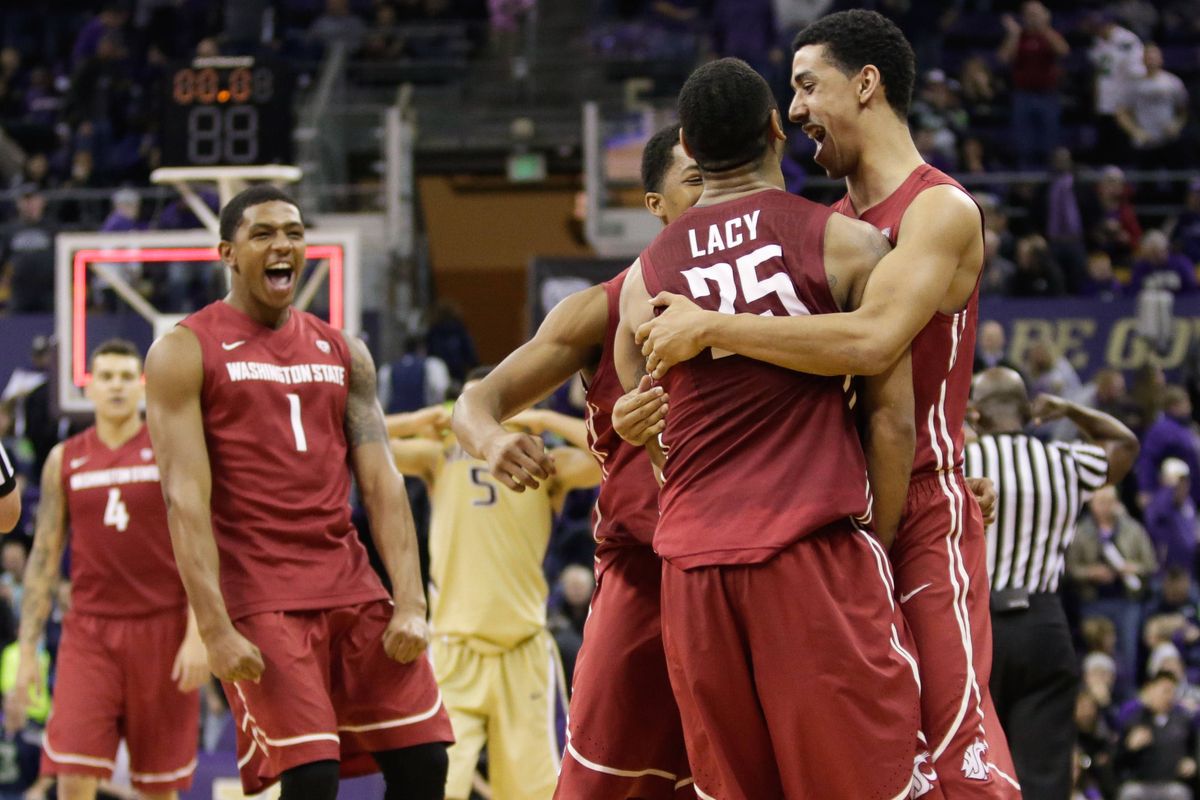 Guard DaVonte Lacy is rushed by his Washington State teammates after the Cougars beat Washington in Seattle on Saturday. (Associated Press)