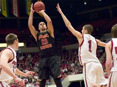 USC guard Daniel Hackett (13) hits a jump shot over WSU guard Klay Thompson.  (Associated Press / The Spokesman-Review)