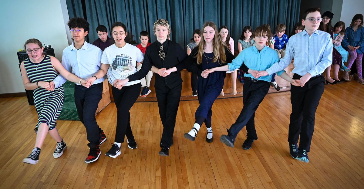 Holy Trinity Greek Orthodox Church Opa Dancers practice the traditional five-step dance Pentozali during a gathering at the church Sunday. The senior dancers are Grace Gustafson, left, James Krueger, Abyssinia Krueger, Emme Teske, Micah Carter and James Treppiedi. Junior members watch from the stage.  (DAN PELLE/FOR THESPOKESMN-REVIEW)