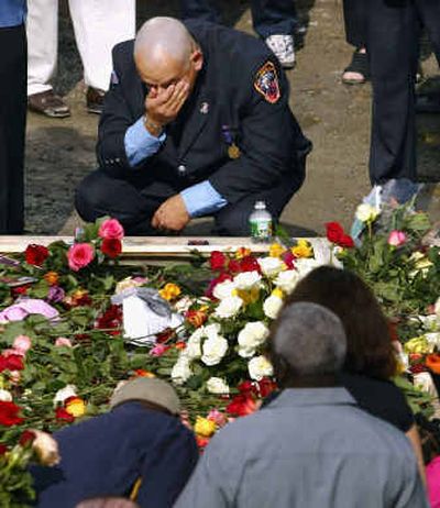 
A New York City firefighter pays respect to Sept. 11 victims Saturday at ground zero. 