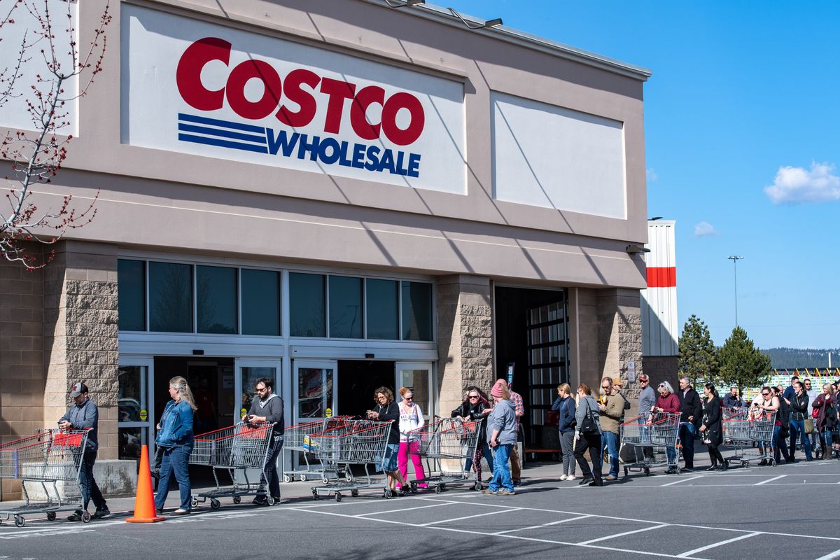 A line of shoppers waits to enter the Costco store in Spokane Valley in March 2020. Plans to add another store in Liberty Lake have stalled.  (Colin Mulvany/The Spokesman-Review)