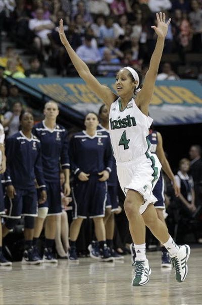 Skylar Diggins celebrates Notre Dame’s overtime victory over Connecticut. (Associated Press)