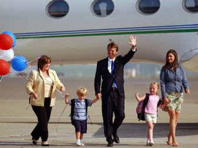 
Sen. John Edwards waves as he arrives with his family at the Pittsburgh airport on Tuesday. Family members, from left to right, his wife Elizabeth, son Jack and daughters Emma and Catharine. 
 (Associated Press / The Spokesman-Review)