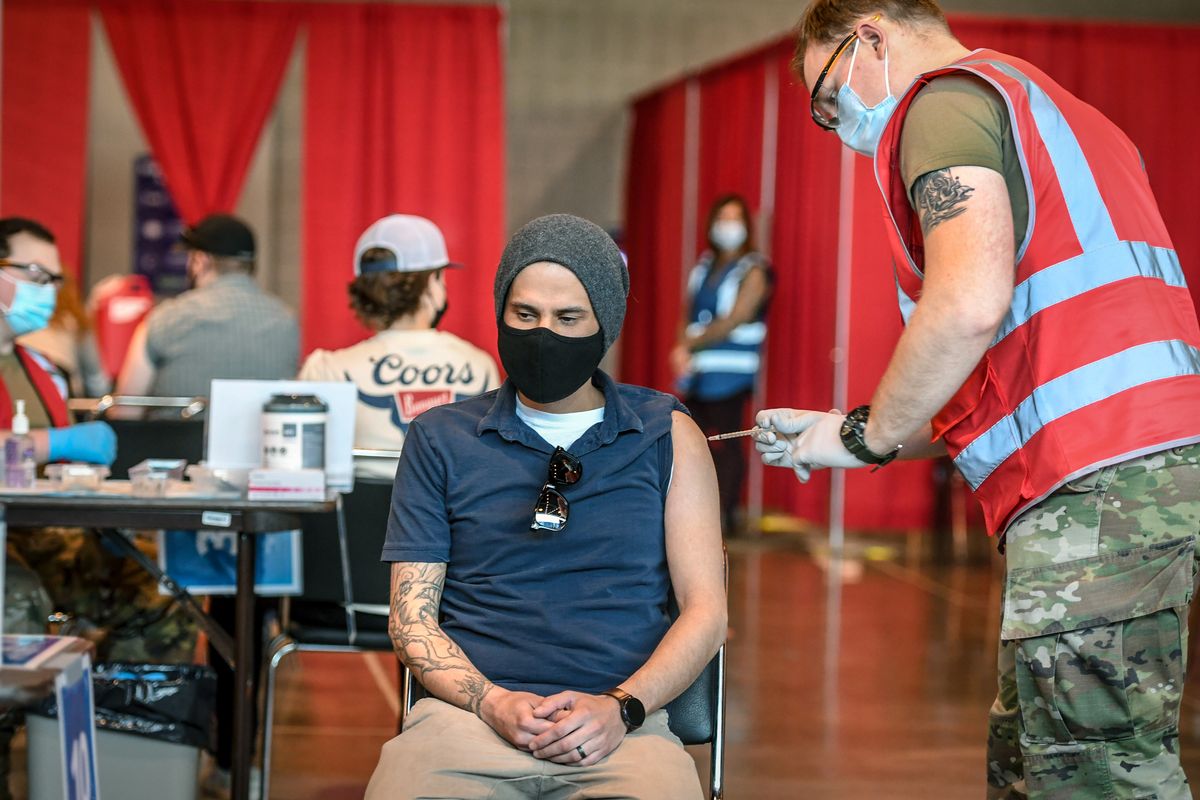 Razziq Khusro, 35, gets his first Moderna vaccination from Jeremy Fitchett of the Army National Guard on Friday, April 2, 2021, at the Spokane Arena. (Dan Pelle/The Spokesman-Review)