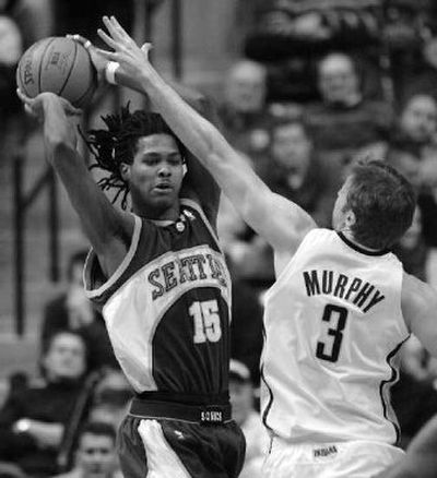 
Seattle's Mickael Gelabale makes a pass under pressure from Indiana's Troy Murphy.
 (Associated Press / The Spokesman-Review)
