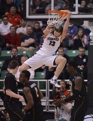 Gonzaga's Kelly Olynyk (13) slam dunks the ball in the first half of their third round of the NCAA Division 1 Men's Basketball Championship game, Saturday, March 23, 2013, at the EnergySolutions Arena in Salt Lake City, Utah. (Xx Xx / The Spokesman-Review)