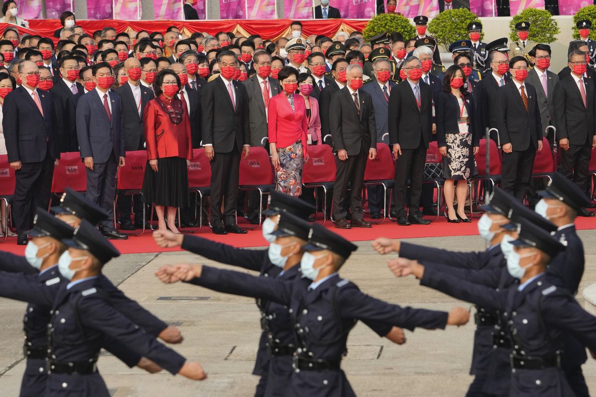 Hong Kong Chief Executive Carrie Lam, center, and other officials attend the flag raising ceremony for the celebration of China