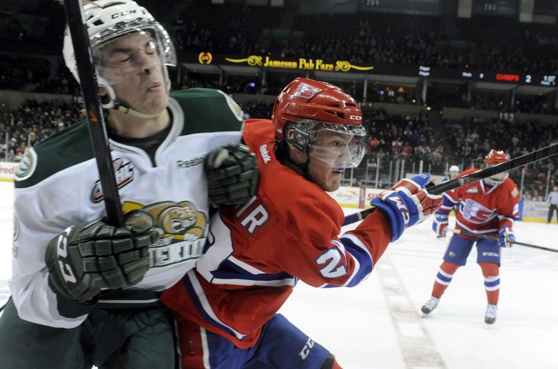 Spokane Chiefs' Jackson Playfair, right, blasts past the Everett Silvertips' Dawson Leedahl, left, along the boards at mid-ice Wednesday, Dec. 11, 2013 at the Spokane Arena. After one period, the Chiefs lead 2-0. (Jesse Tinsley / The Spokesman-Review)