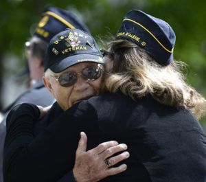 World War II veteran Bob Templin gets a hug after receiving a Veteran of the Year award at the Memorial Day ceremonies begin Monday, May 26, 2014, at Evergreen Cemetery in Post Falls. (Jesse Tinsley/THE SPOKESMAN-REVIEW file photo)