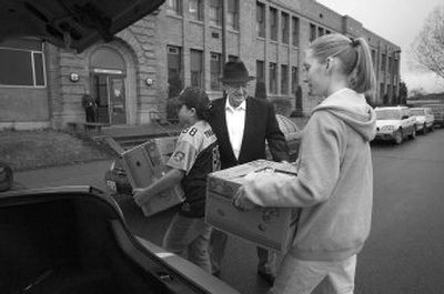 
Bernard Goble watches Havermale students Chasity Morales,  left,  and Gwendolyn Dunn help carry the boxes of bananas that he has just delivered to the school. Many students have come to appreciate the monthly deliveries.  
 (CHRISTOPHER ANDERSON Photo / The Spokesman-Review)