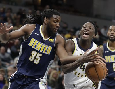 Indiana Pacers’ Victor Oladipo (4) is fouled by Denver Nuggets’ Kenneth Faried during the second half of an NBA basketball game, Sunday, Dec. 10, 2017, in Indianapolis. (Darron Cummings / Associated Press)
