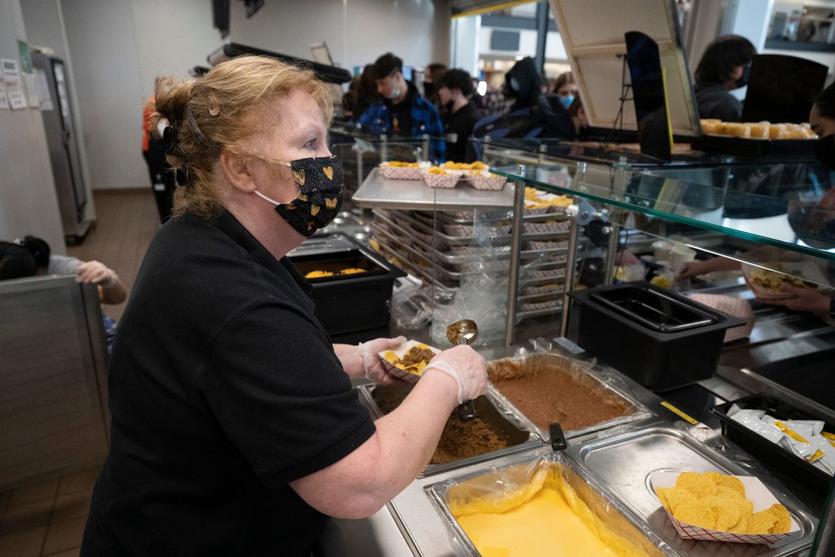 Debbie Richardson takes a flurry of orders for nachos as the lunch hour begins at Lewis and Clark High School Friday, Feb. 11, 2022.  (Jesse Tinsley/THE SPOKESMAN-REVIEW)