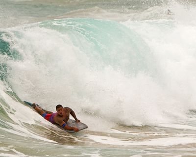 A boogie boarder barrels over a wave Friday at Sandy Beach Park in Honolulu. (Associated Press)