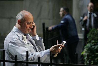 Broker Edward Stephan Jr. talks with a customer outside the New York Stock Exchange before the start of trading on Friday.  (Associated Press / The Spokesman-Review)