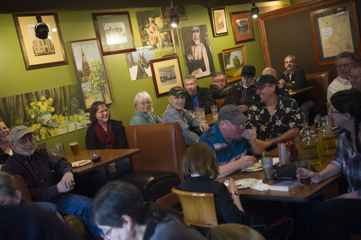 Tom Wobker, aka the Bard of Sherman Avenue, center, smiles before being unveiled during Blogfest 2016 on Saturday, Feb. 20, 2016, in Coeur d’Alene. (Tyler Tjomsland / The Spokesman-Review)