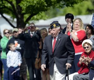 World War II veteran Frank Henderson walks forward to accept a Veteran of the Year award at the Memorial Day ceremonies begin Monday, May 26, 2014 at Evergreen Cemetery in Post Falls. (Jesse Tinsley/SR photo)