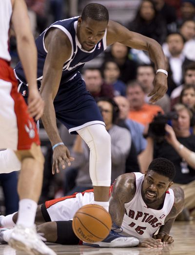 Oklahoma City Thunder forward Kevin Durant, left, steals the ball from Toronto Raptors forward Amir Johnson in overtime. (Associated Press)