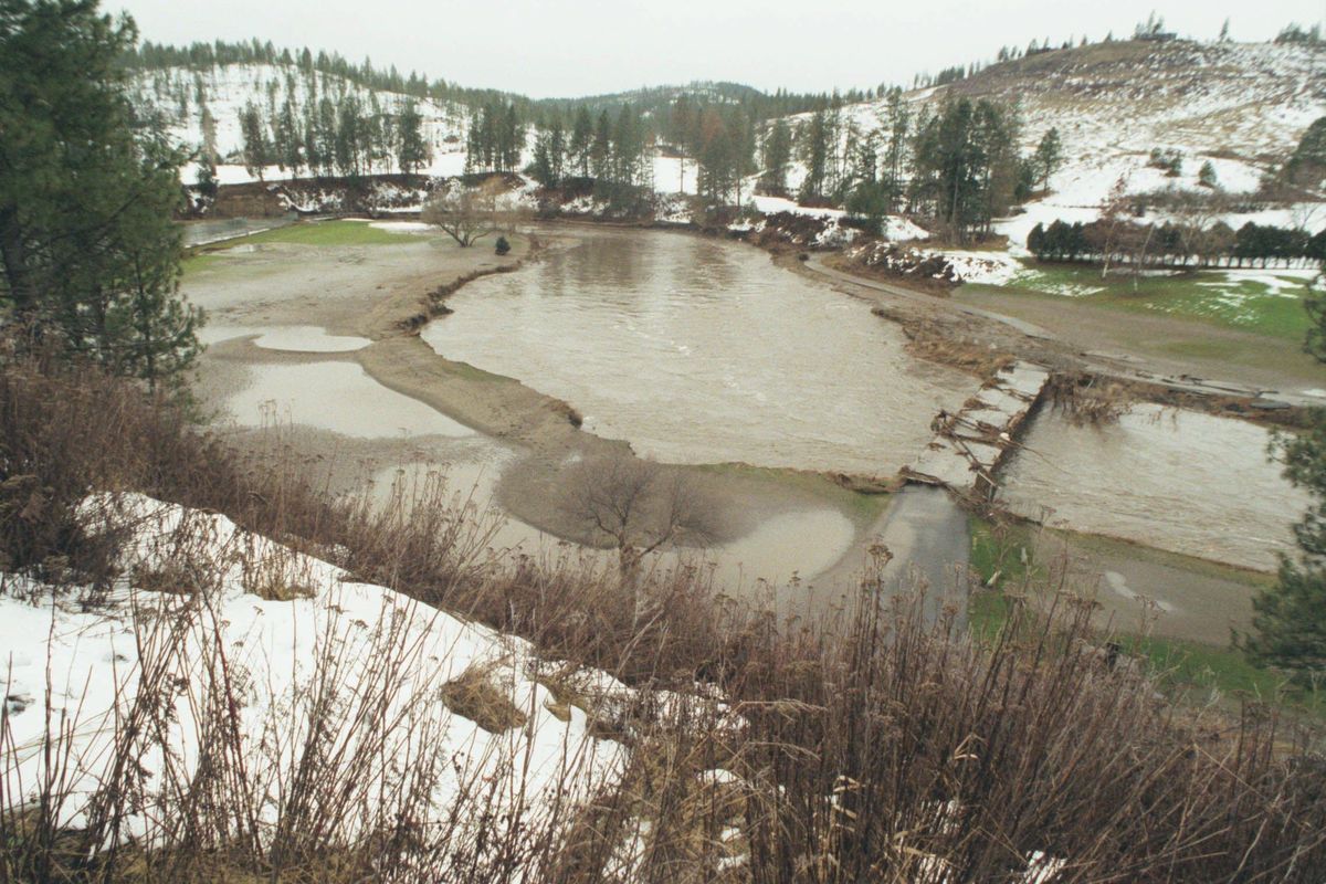 FILE – Looking upstream from the bridge at Hangman leading to the 10th feairway shows the extant of flooding at the local course in January 1997. The 9th fairway at left has extensive mud and the bridge is covered with logs and other debris. (Christopher Anderson / The Spokesman-Review)
