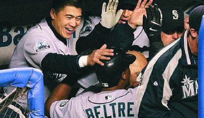 
Seattle Mariners' Adrian Beltre is congratulated by his teammates after hitting a solo home run against the New York Yankees.
 (Associated Press / The Spokesman-Review)