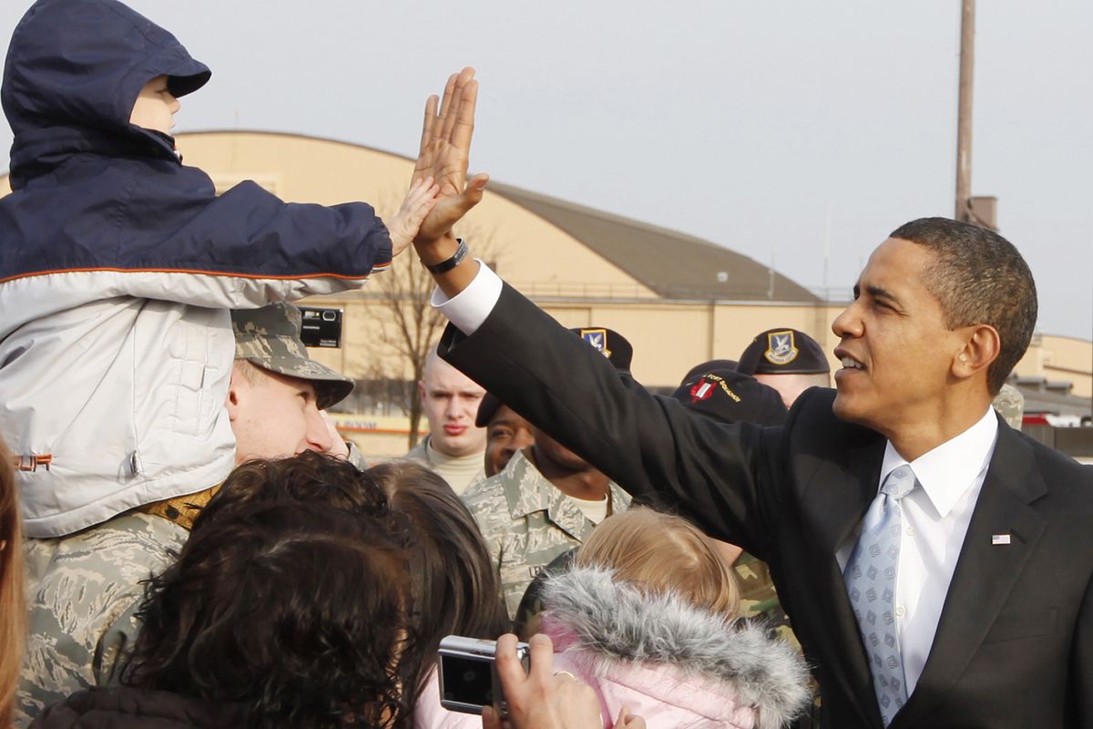 President Barack Obama high fives a young boy as he greets military personnel and their families before boarding Air Force One at Andrews Air Force Base in Maryland, Tuesday, Feb. 10, 2009. Obama will hold a town hall style meeting about the economy in Fort Myers, Fla., before returning to Washington.  (Charles Dharapak / AP)