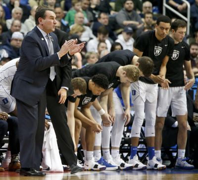 Duke head coach Mike Krzyzewski, left, claps beside his team as it plays Rhode Island in a second-round game in the men’s NCAA Tournament on Saturday, March 17, 2018, in Pittsburgh. (Keith Srakocic / Associated Press)