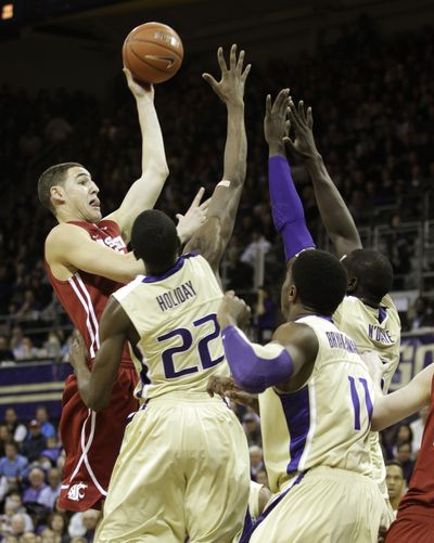 Washington State’s Klay Thompson shoots over a trio of Huskies during the first half. (Associated Press)