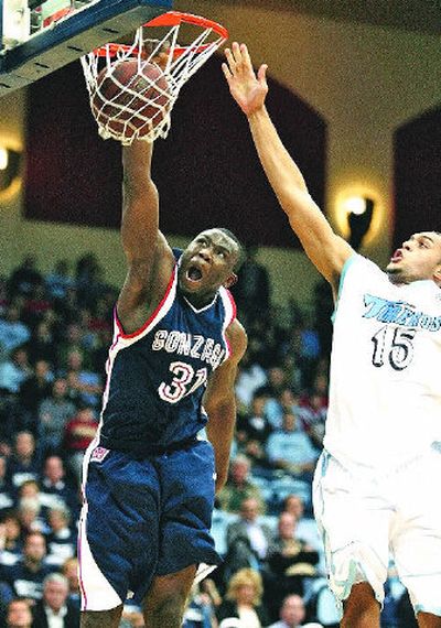 
Gonzaga's Abdullahi Kuso dunks on San Diego's Ray Murdock in the first half of the Bulldogs' 74-64 win Monday night in San Diego.  
 (Associated Press / The Spokesman-Review)