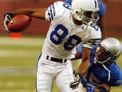 
Wide receiver Marvin Harrison caught 12 passes for 127 yards and three touchdowns in Indianapolis' 41-9 win over Detroit. 
 (Associated Press / The Spokesman-Review)