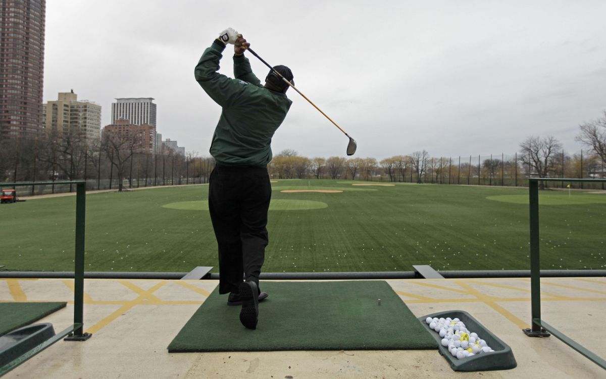Golf teaching pro Emmanuel Worley hits balls at a driving range in Chicago. Worley came to the game late and never quite made up enough ground to reach the PGA Tour.  (Associated Press / The Spokesman-Review)