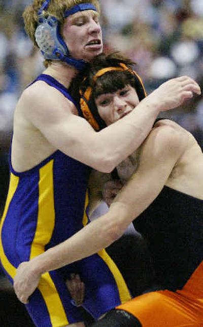 
Kellogg's Jerad Madsen, left, fends off a charge by Fruitland's Josh Gifford during Friday's State 3A semifinals at 112 pounds. 
 (Darin Oswald/Special to / The Spokesman-Review)