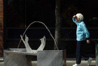 
Water  arcs over artist Rann Haight's stainless steel fountain, 