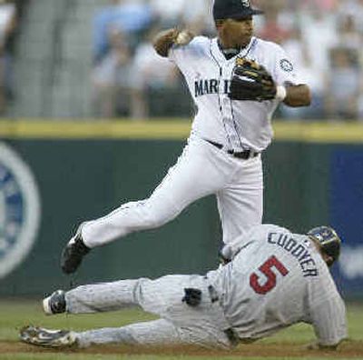 
Twins' Michael Cuddyer breaks up a double-play attempt by Mariners shortstop Jose Lopez in the second inning. 
 (AP / The Spokesman-Review)