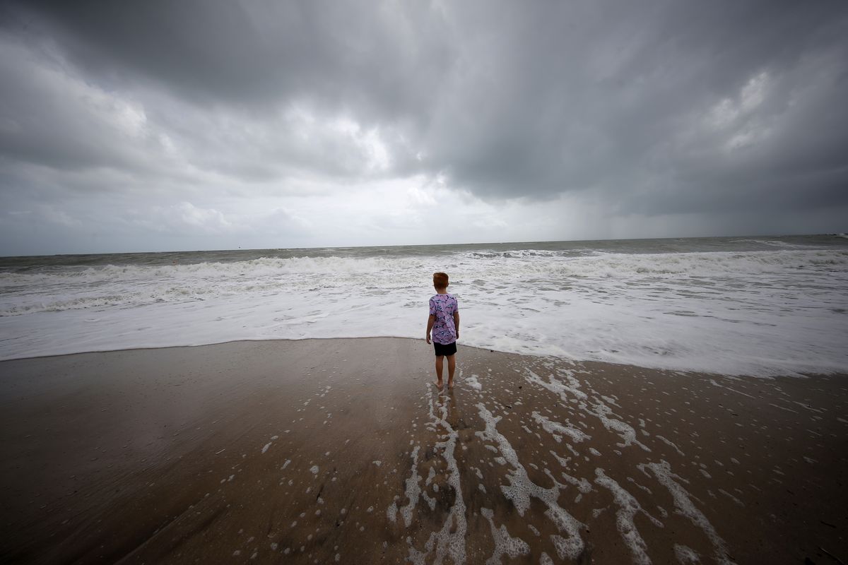 Weston Lee, of Vero Beach, stands near the high surf from the Atlantic Ocean, in advance of the potential arrival of Hurricane Dorian, in Vero Beach, Fla., Monday, Sept. 2, 2019. In a report released Wednesday, Dec. 8, 2021, the National Academy of Sciences says to fight climate change the world needs to look into the idea of making the oceans suck up more carbon dioxide.  (Gerald Herbert)