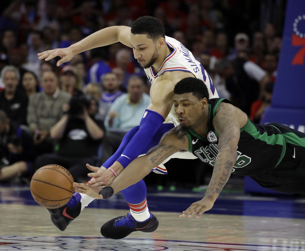 Boston Celtics‘ Marcus Smart, right, and Philadelphia 76ers’ Ben Simmons chase after a loose ball during the first half of Game 3 of an NBA basketball second-round playoff series, Monday, May 7, 2018, in Philadelphia. (Matt Slocum / Associated Press)