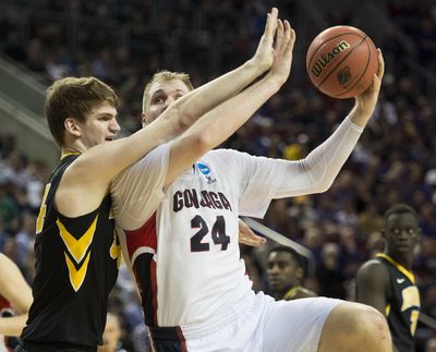 Gonzaga center Przemek Karnowski, right, will not participate in Senior Night, with one of his options being a return to the Bulldogs after his senior season was cut short after five games because of a back injury. (Colin Mulvany colinm@spokesman.com)