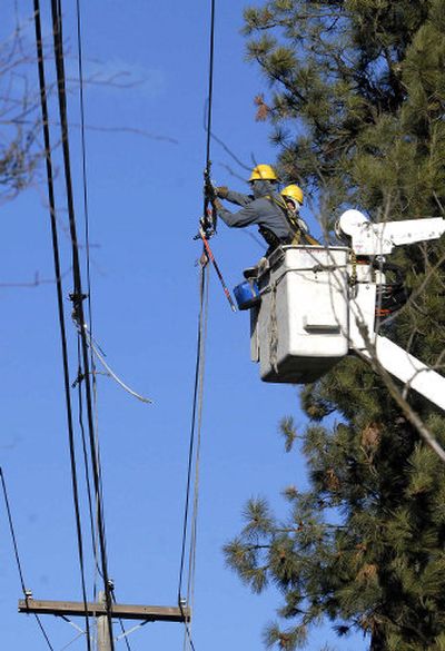 
Avista linemen Brian Bethman, left, and Brian Dollar repair a line Saturday in Spokane Valley. 
 (Dan Pelle / The Spokesman-Review)